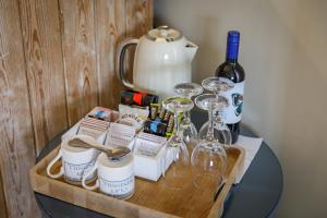 a table with wine glasses and wine bottles on it at Cley Windmill in Holt
