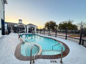a large swimming pool with a black fence at Crystal Inn - Garth Rd in Baytown