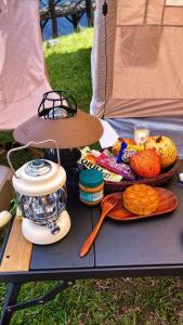 a picnic table with food and a blender on it at Bamboo Glamping Tà Xùa in Bắc Yên