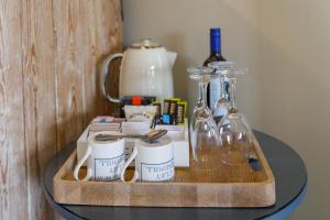a tray with a bottle of wine and glasses on a table at Cley Windmill in Holt