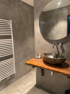a bathroom with a sink and a mirror at The Rock in Zandvoort +31 photos