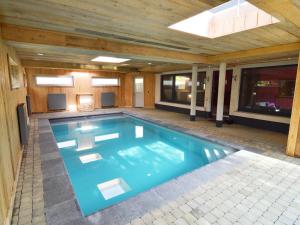 a swimming pool in a house with a wooden ceiling at Appealing holiday home in Malm dy with indoor pool in Malmedy