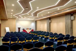 a conference room with blue chairs and a table at PASSIONS HOTEL EDATHUA - Alappuzha in Champakulam