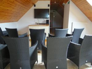 a group of chairs in a room with a television at Holiday home in Waimes Robertville with sauna in Waimes