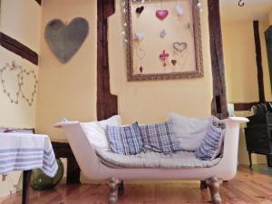 a couch with pillows on it in a room at A studio apartment on the first floor of a wine grower s house in Riquewihr