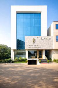 a building with a sign on the front of it at The Sapphire Hotel in Belgaum