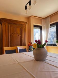 a table with a vase with flowers on it at Weingut Sauer-Kettermann in Enkirch
