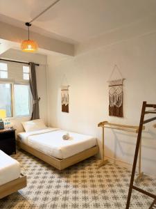 a bedroom with two beds and two windows at Closca Hostel Koh Tao in Ko Tao +88 photos