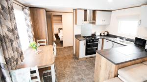 a kitchen with a table and a counter top at 4. Supreme OD 3 Caravan with Decking in Ringwood
