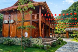 a wooden house with red lights on it at Khu du lịch nghỉ dưỡng Thạch Lâm Retreat in Thanh Hối +77 photos