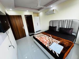 a bedroom with a bed and a television in it at Hotel Crystal Haven in New Delhi