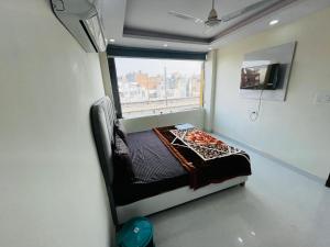 a small room with a bed and a window at Hotel Crystal Haven in New Delhi