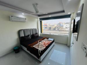 a small room with a bed and a window at Hotel Crystal Haven in New Delhi