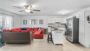 a living room with a red couch and a kitchen at 209 E Andrews Ave, Unit A in Wildwood