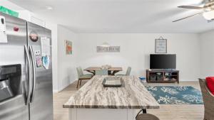 a living room with a refrigerator and a table at 209 E Andrews Ave, Unit A in Wildwood
