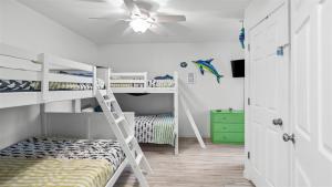 a room with two bunk beds and a ceiling fan at 209 E Andrews Ave, Unit A in Wildwood