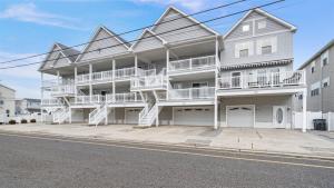 a large white building with stairs on the side of it at 209 E Andrews Ave, Unit A in Wildwood