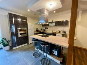 a kitchen with a large island in the middle at AppartCosy 19 in Vitré +11 photos