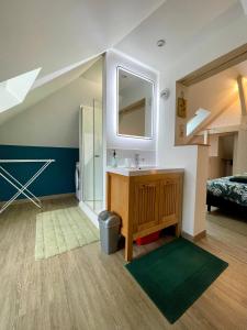 a bathroom with a sink and a mirror at AppartCosy 19 in Vitré