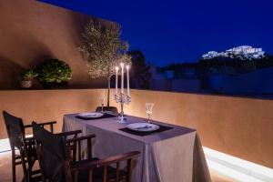a table with a purple table cloth and candles on it at Architects Masterpiece Villa with Private Rooftop in Athens