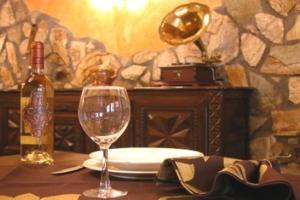 a table with a bottle of wine and a glass at Hostal la Cepa in Aldeanueva de Ebro +25 photos