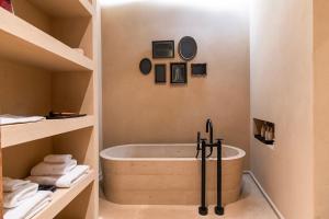 a bathroom with a bath tub in a room at Architects Masterpiece Villa with Private Rooftop in Athens