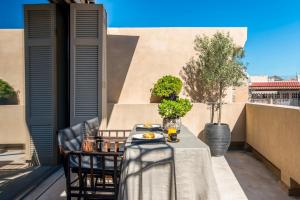 a table on a balcony with food on it at Architects Masterpiece Villa with Private Rooftop in Athens
