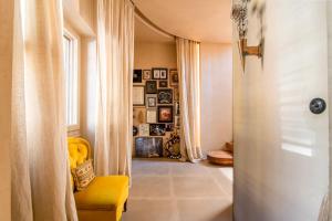 a hallway with a yellow chair and a window at Architects Masterpiece Villa with Private Rooftop in Athens