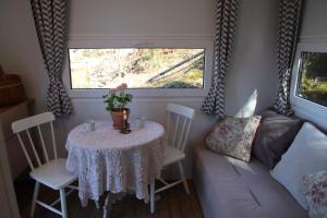 a small table in a room with a couch and a window at Lillstugorna in Ljungskile