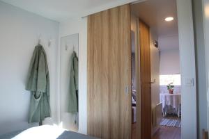 a bedroom with a bed and a wooden door at Lillstugorna in Ljungskile