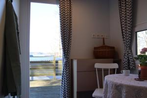 a room with a table and a table and a window at Lillstugorna in Ljungskile