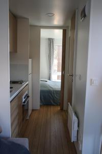 a kitchen and a bedroom with a bed and a window at Lillstugorna in Ljungskile