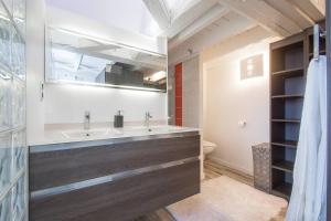 a bathroom with a large tub and a sink at AppartCosy 04 in Vitré