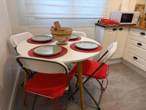 a table with four chairs and a bowl of food on it at Las Alas in Avilés +12 photos