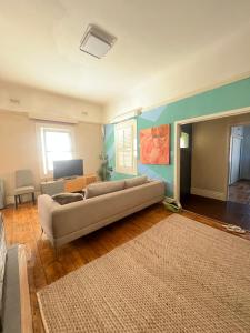 a living room with a couch and a rug at Seaside Sanctuary in Aspendale