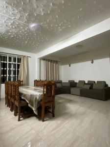 a living room with a table and a couch at Coastal Retreat Penthouse in Pereybere