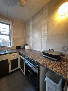 a kitchen with a counter top with a pan on it at Seaside Sanctuary in Aspendale