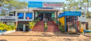 a building with a staircase in front of a store at Railview Residency in Alleppey