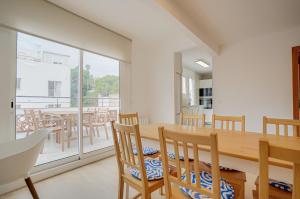 a dining room with a wooden table and chairs at Molí de Mar - Smart Hotel in Lloret de Mar