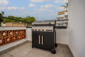 a grill on the balcony of a building at Molí de Mar - Smart Hotel in Lloret de Mar