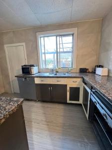 an empty kitchen with a sink and a window at Seaside Sanctuary in Aspendale +5 photos
