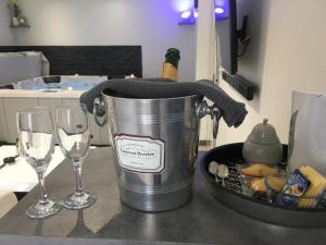 a bucket on a counter with two wine glasses at Appart&Spa in Toulouse