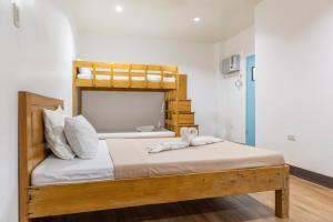 a bedroom with a bunk bed with a stuffed animal on it at Anda De Boracay White Sand Resort in Anda