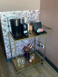a shelf with a coffee maker and glasses on it at The Rock in Zandvoort