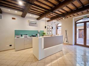 a large kitchen with a white island in a room at Hotel La Pace in Asciano +109 photos