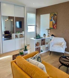 a living room with a couch and a chair at AppartCosy 10 in Vitré