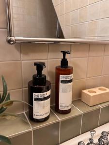 two bottles ofodorizers sitting on a bathroom shelf at yua sugar home in Daegu +20 photos