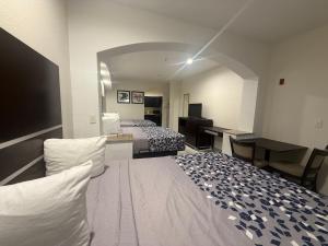 a hotel room with two beds and a desk at Crystal Inn - Garth Rd in Baytown +51 photos