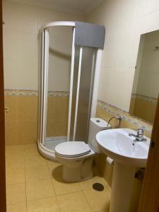 a bathroom with a shower and a toilet and a sink at REMANAL Residencia in Salamanca