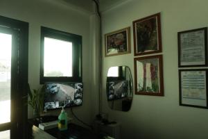 a room with a mirror and pictures on the wall at Tukad Guest House in Sampong